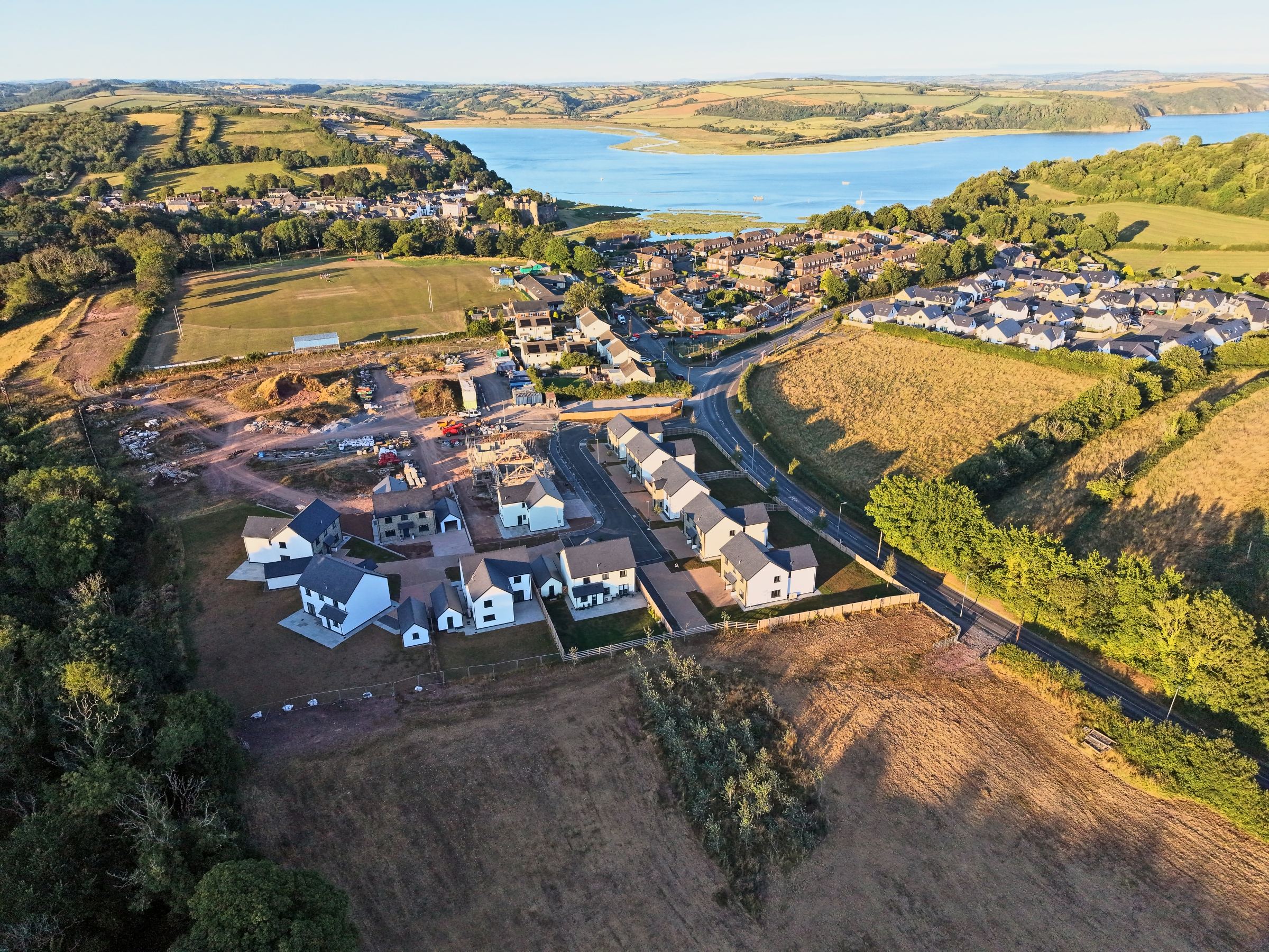 The new homes above the estuary at Laugharne in golden evening light