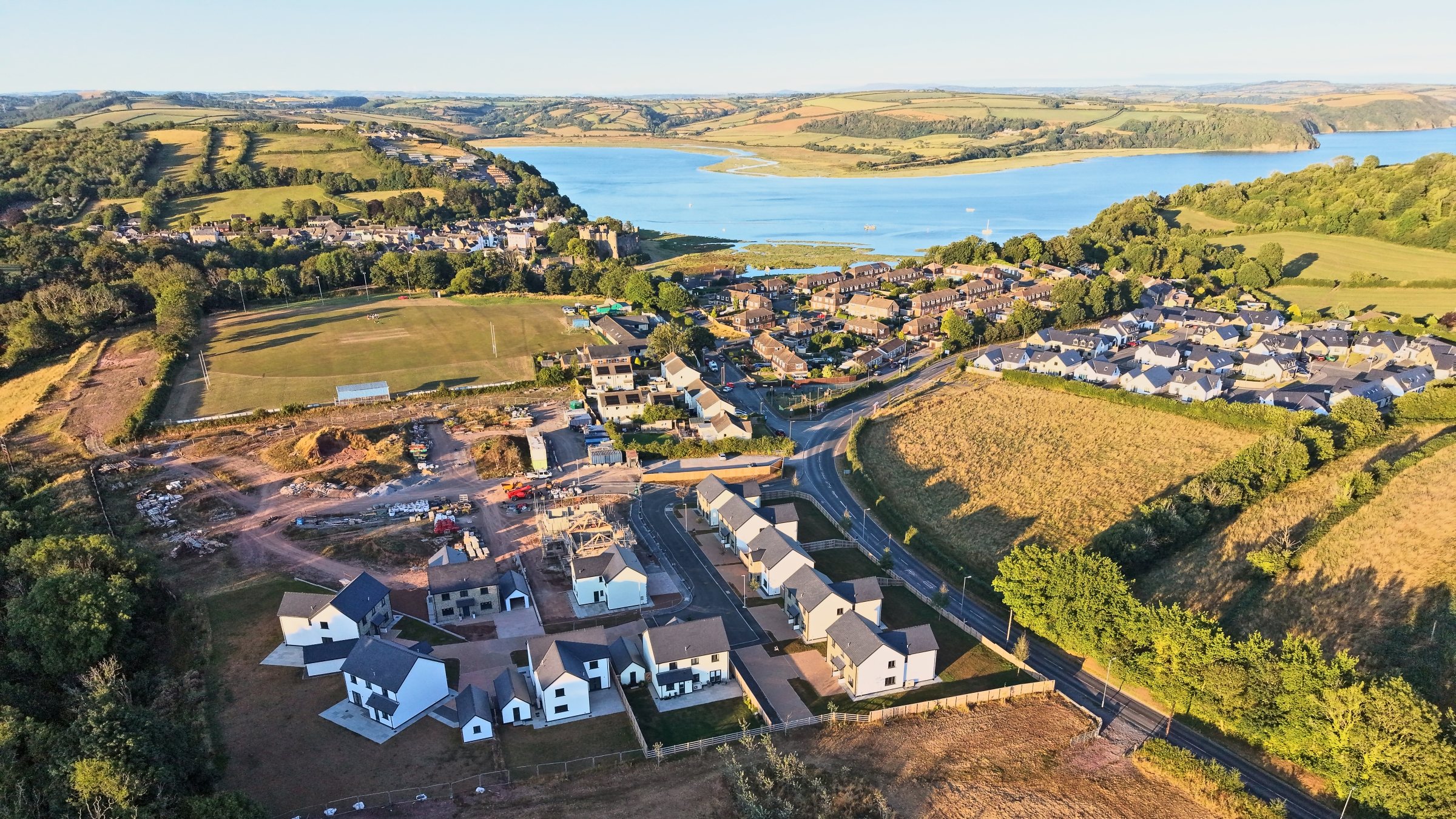 Cl&ocirc;s Hugdon, Laugharne &mdash; the new homes above the estuary in golden evening light