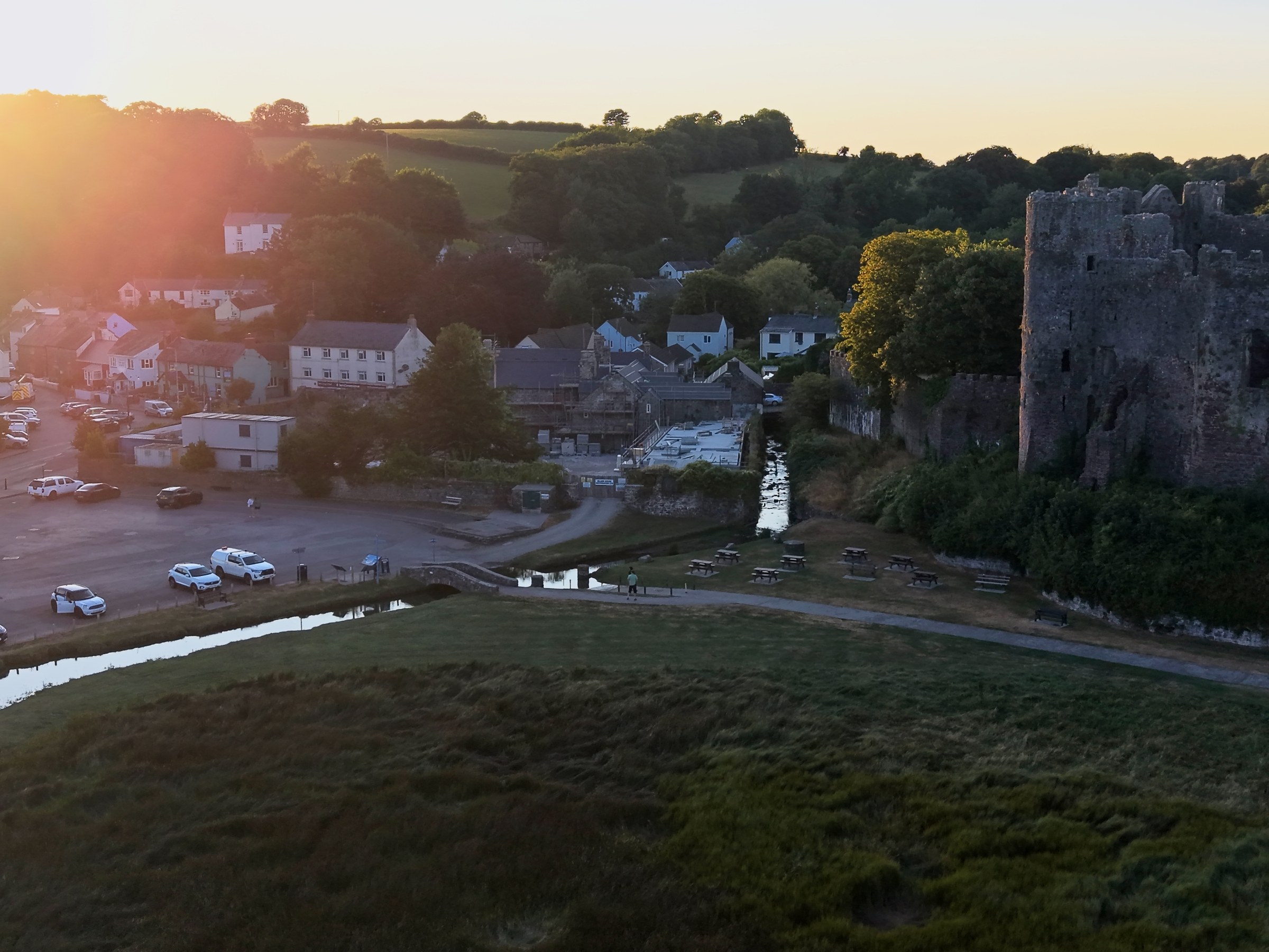 Laugharne Castle and the town at dusk, beside the T&acirc;f estuary