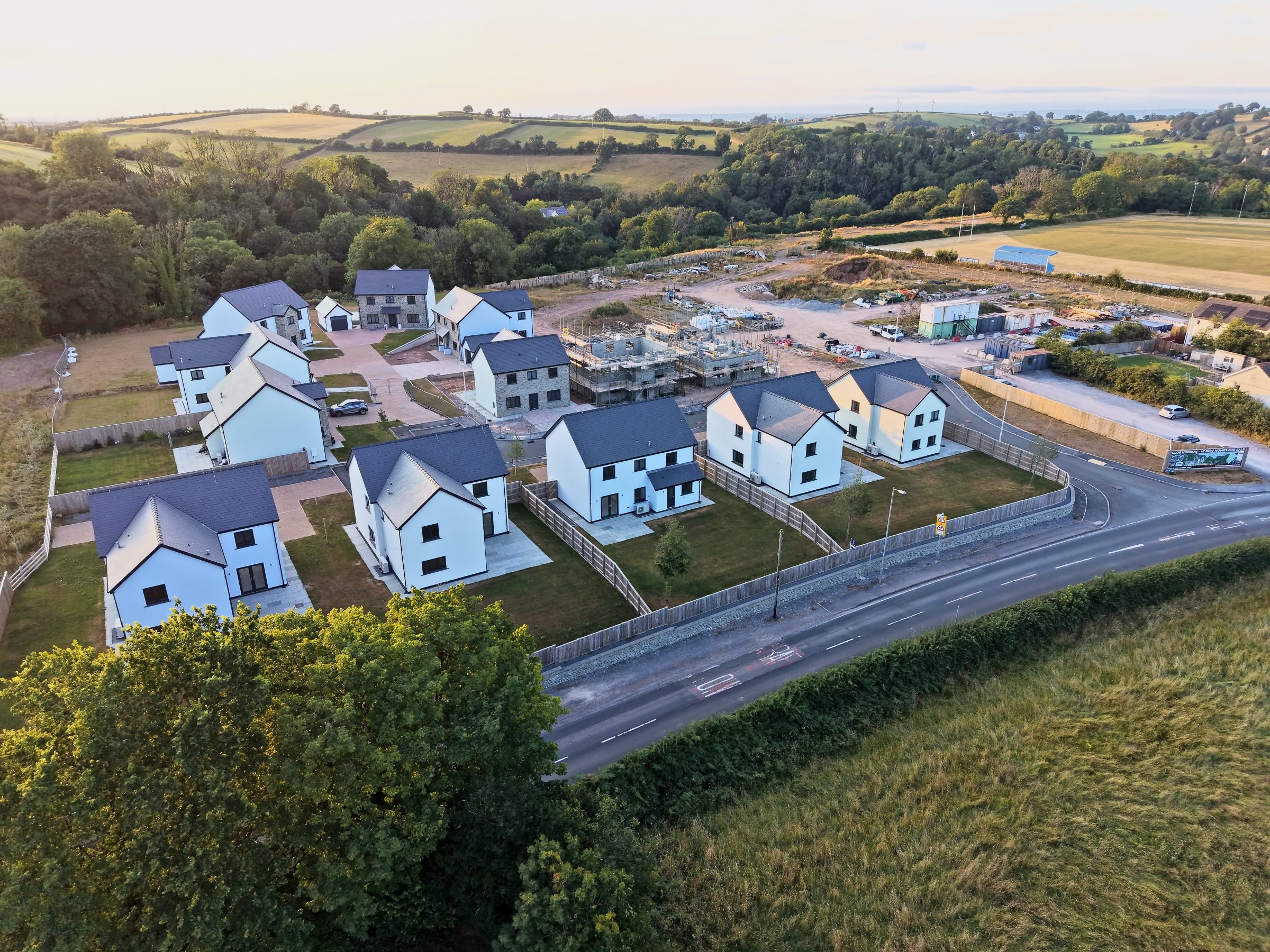 Clôs Hugdon, Laugharne — the new homes in evening side light from the air