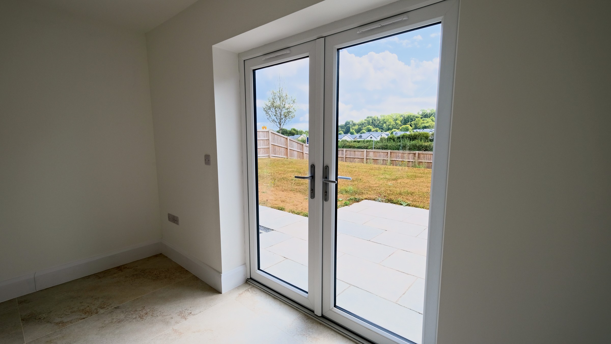 House 5, The Oak &mdash; the living room with French doors opening to the rear garden
